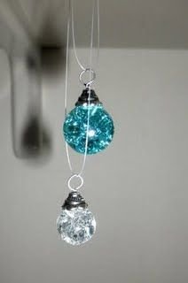 Bake marbles at 325/350 for 20 min. Put in ice water to make them crack on the inside. Glue end caps to them with starter rings to create pretty pendants!